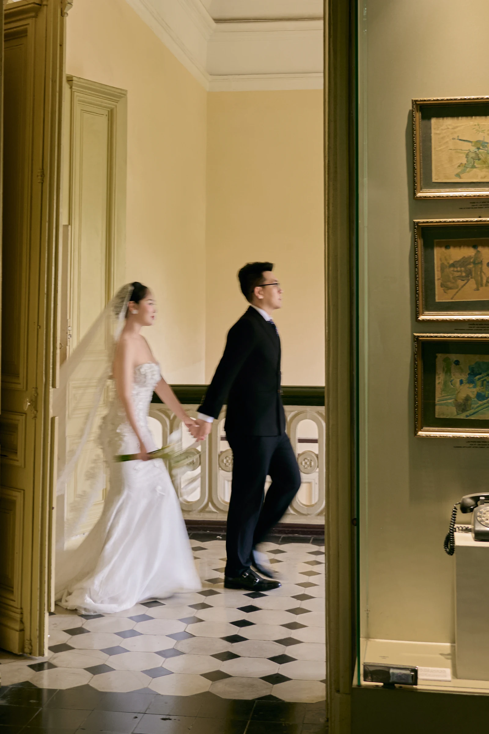 Hand in hand, they walk on into the next room